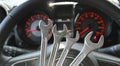 Four Different Size Chrome Spanners In Front Of Defocused Instrument Cluster With Red Backlight Royalty Free Stock Photo