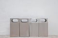 Four of different types of grey metal bins lays in front of whit Royalty Free Stock Photo