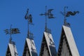 Four different weathercocks on the roof of the building Royalty Free Stock Photo