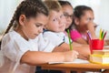 Four diligent pupils studying at classroom Royalty Free Stock Photo