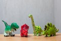 Four dinosaurs toys standing on a wooden floor. Royalty Free Stock Photo