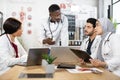 Four diverse medical workers having discussion at office Royalty Free Stock Photo