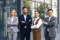 Confident business team in formal attire standing outside office building Royalty Free Stock Photo