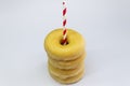 Four Donuts or Classic Donuts Stack with One Red Stripe Straw on a White Background