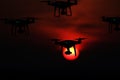 Silhouette of drones in the sky, red sunset Royalty Free Stock Photo