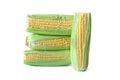 Four ears of corn stand and lie on white table, isolated Royalty Free Stock Photo