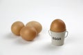 Four eggs in egg cups on a whote table white background Royalty Free Stock Photo