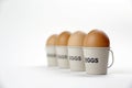 Four eggs in egg cups on a whote table white background Royalty Free Stock Photo