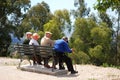 Four elderly Spanish men on a bench.