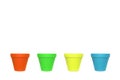 Four empty ceramics flowerpots in a row with different colours Royalty Free Stock Photo