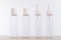 Four empty clear plastic storage and spray bottles Royalty Free Stock Photo