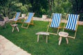 Four empty deck chairs with white and blue stripes Royalty Free Stock Photo