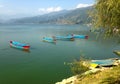 Four empty tourist boats on the lake Pheva, mountain view Royalty Free Stock Photo