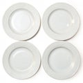 Four empty white plates aligned in rows (top view) isolated on white background Royalty Free Stock Photo