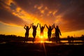 Four engineers are working at night. Four girls jumping in the air at sunset Royalty Free Stock Photo