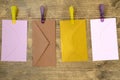 Four envelopes hang with clips and rope