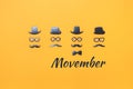 Four faces with mustaches for Movember on yellow orange