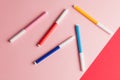 Four felt-tip pens isolated on pink and red background Royalty Free Stock Photo