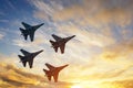 Four fighter jets in the shape of a diamond in the sky beautiful sunset