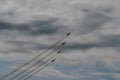 four fighter planes fly up steeply at a air show