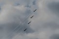 four fighter planes fly up steeply detail