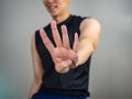 Four finger gesture by man wearing sport clothes