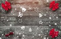 Four fir branches with red bows, and xmas handmade toys creating a circle on a wooden gray background, with space for text