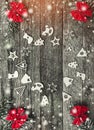 Four fir branches with red bows, and xmas handmade toys creating a circle on a wooden gray background, with space for text