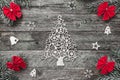 Four fir branches with red bows, and xmas handmade toys on wooden gray background, with evergreen big toy in center Royalty Free Stock Photo