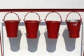 Four fire buckets hanging Royalty Free Stock Photo