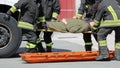 four firemen charge a wounded person on a stretcher Royalty Free Stock Photo