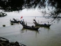 Four fishing boats are anchored on the beach against a bright blue sky Royalty Free Stock Photo