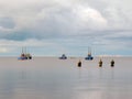 Four fishing boats in the calm water of Lake Ilmen in the Novgorod region, Russia