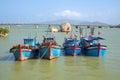 Four fishing schooners are up on the river Kai before going into the sea on a sunny day. Nha Trang, Vietnam