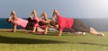 Four fit young women doing pilate exercises against fitness interface