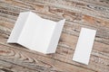 Four - fold white template paper on wood texture . Royalty Free Stock Photo