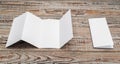 Four - fold white template paper on wood texture . Royalty Free Stock Photo