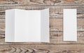 Four - fold white template paper on wood texture . Royalty Free Stock Photo