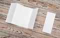 Four - fold white template paper on wood texture . Royalty Free Stock Photo