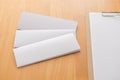 Four fold white template paper with wooden clipboard on wood background Royalty Free Stock Photo