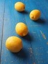 Four fresh organic lemon fruits on a wooden table