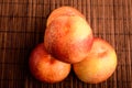 Four fresh ripe organic nectarines on a wooden brown table, top view or flat lay photo of healthy fruits Royalty Free Stock Photo