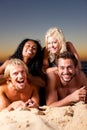 Four friends at the beach with sunset Royalty Free Stock Photo