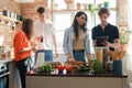 Four friends cooking home pizza and celebrating event together Royalty Free Stock Photo