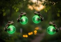Four frogs hanging from tree branches with green lights outdoor Royalty Free Stock Photo