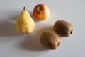 Four fruits with apple pear and two kiwis