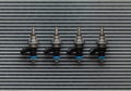 Four fuel nozzles of the injector are vertical lie against the background of the cooling radiator
