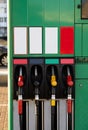 Four fuel pumps at a gas station.