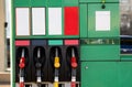 Four fuel pumps at a gas station.