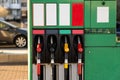 Four fuel pumps at a gas station.